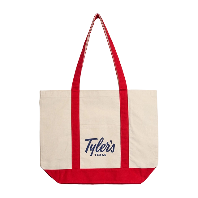 Canvas tote bag with red handles, featuring the text 