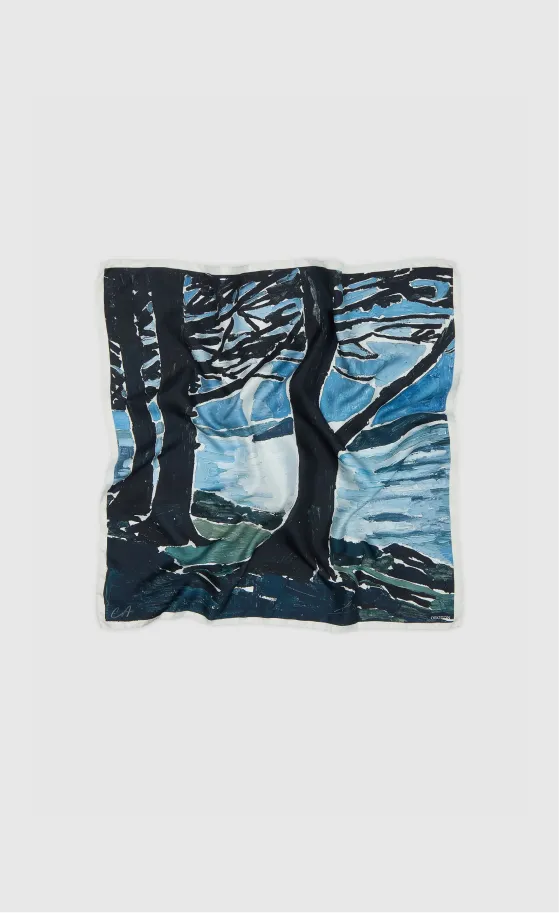 A crumpled scarf with a blue and black landscape design.