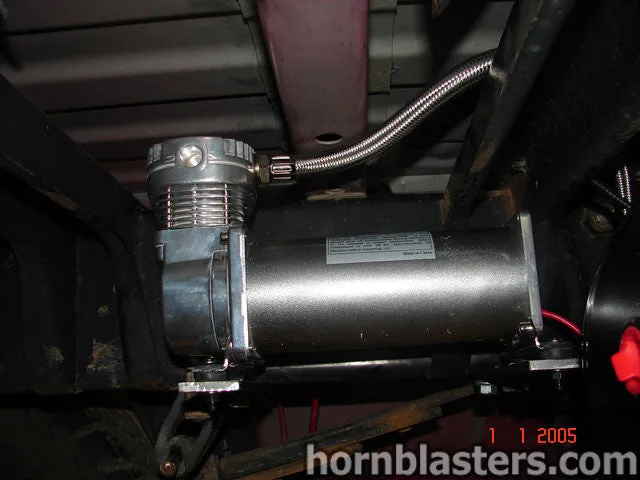 Front-side view of Josh's red 2004 Dodge Ram 2500 train horn install photo 2