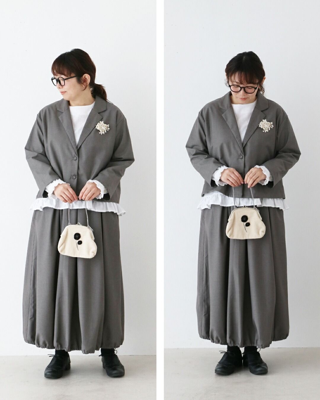 A person wearing a gray outfit with a cute bag.