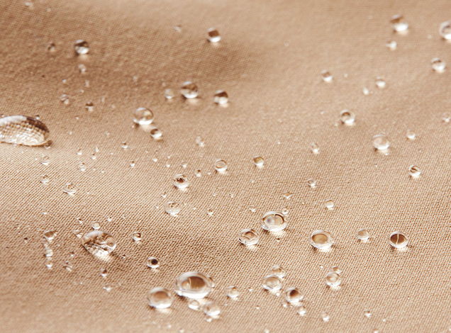 Water droplets on a beige surface.