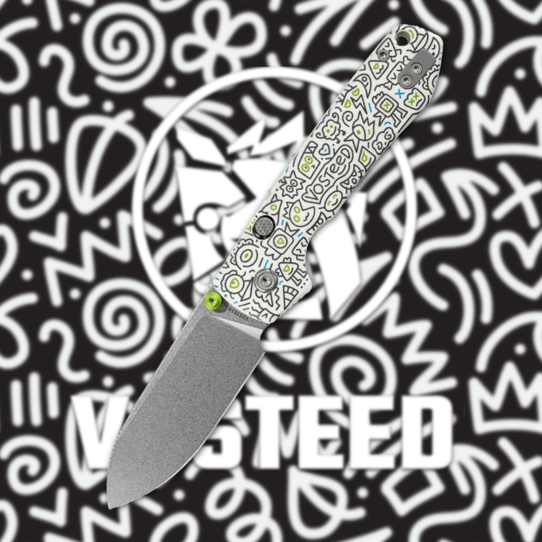 A decorative folding knife on a patterned black background.