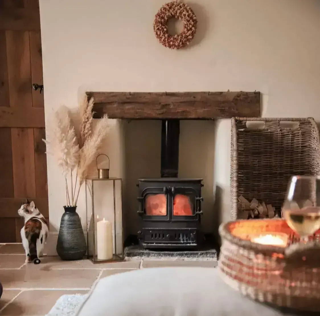 Lit fireplace in cosy lounge setting.