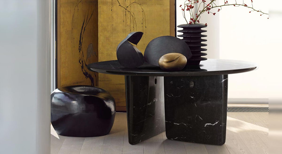 Decorative Tobi Ishi table with vases and floral arrangement in modern interior.