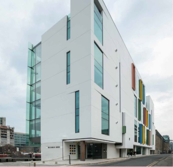Modern white building with ventilated facades and colourful accents.