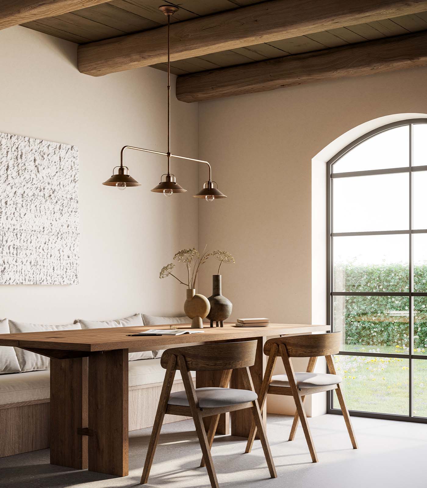 Brass pendant lights above a rustic farmhouse style dining area