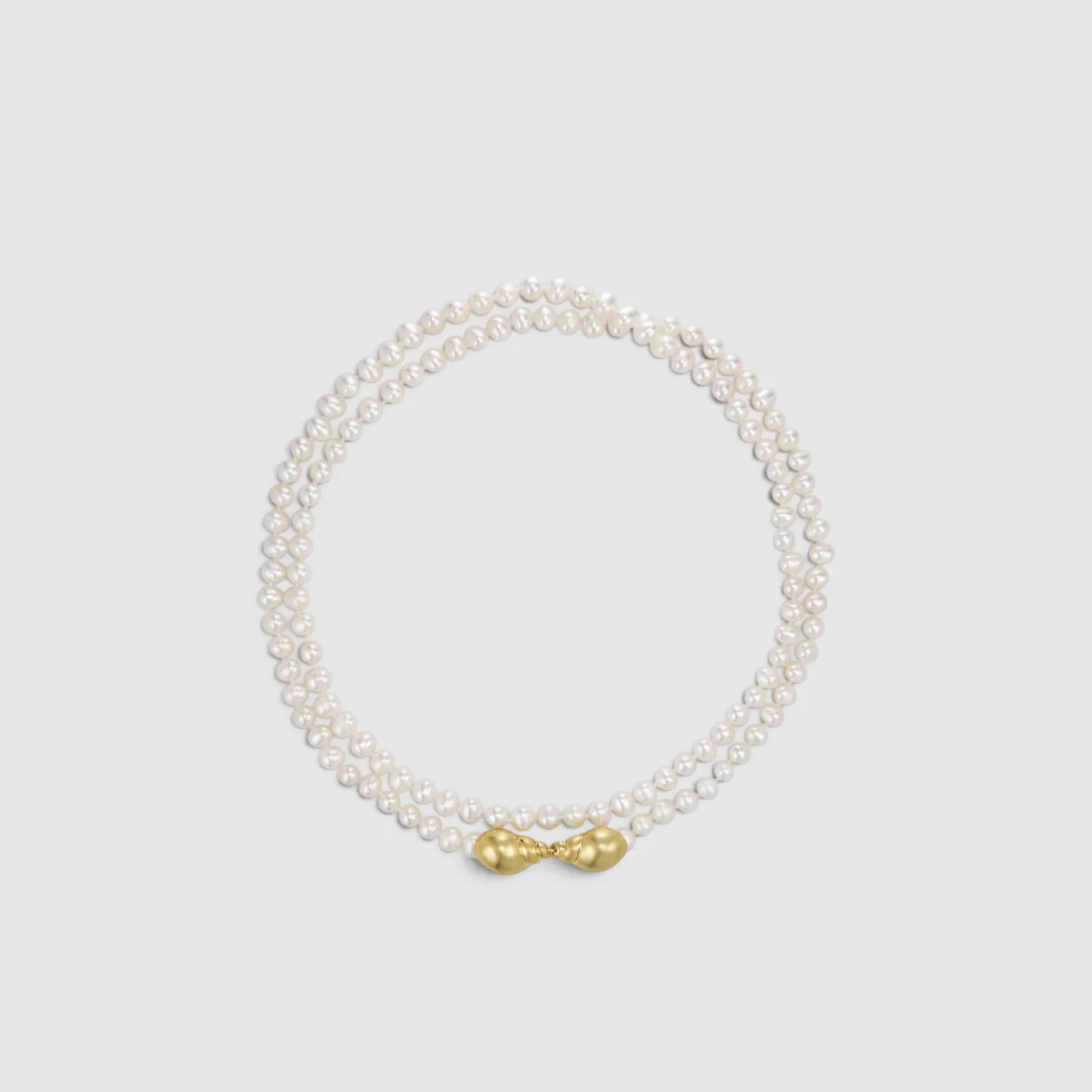 A pearl necklace with a golden clasp.