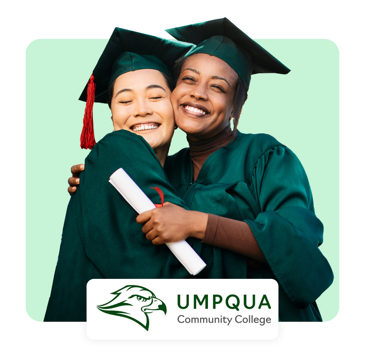 Two graduates in caps and gowns embracing, smiling joyfully.