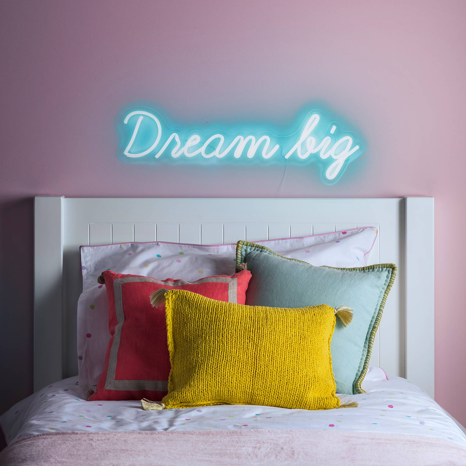 Dream big neon light illuminated and displayed on wall above bed
