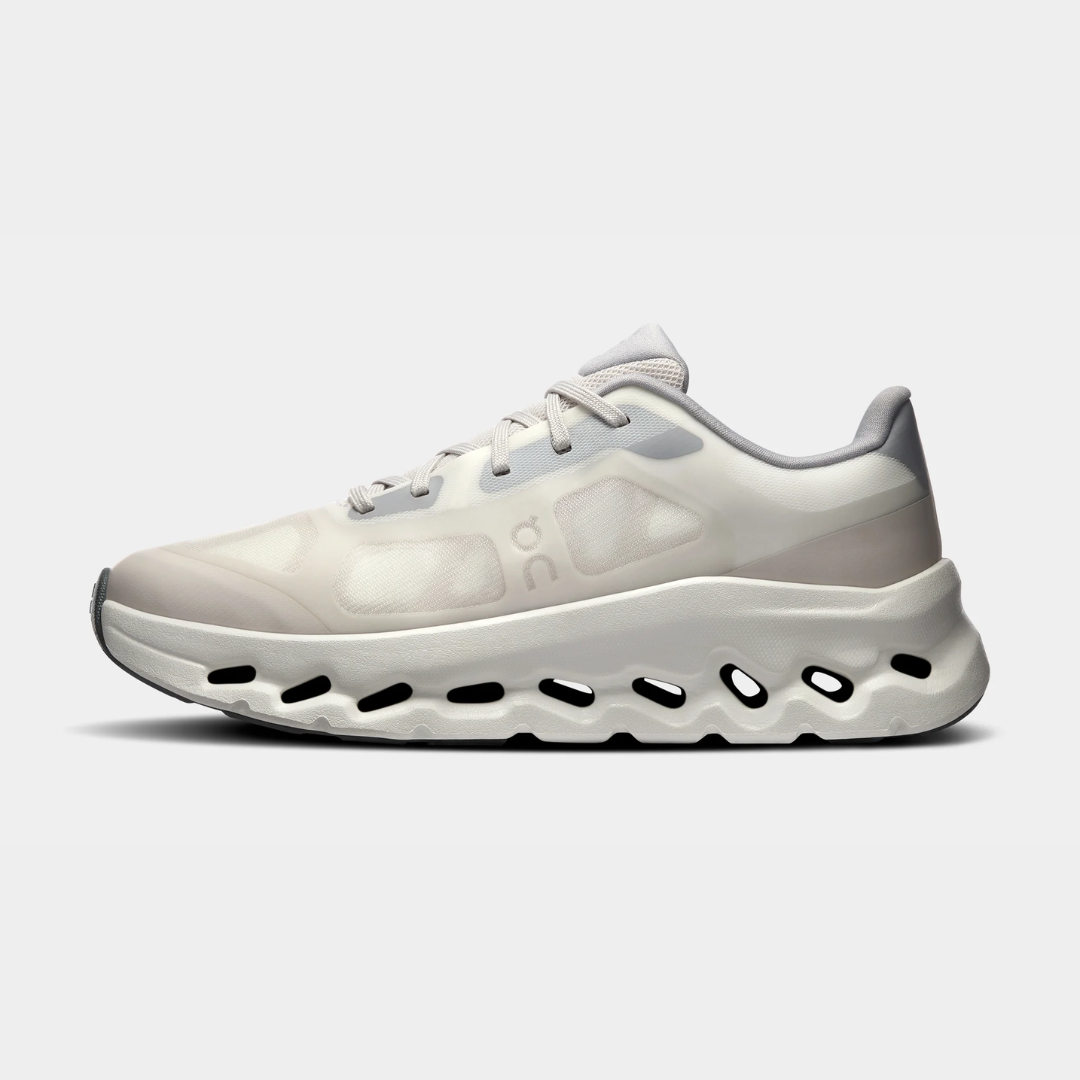 A sleek pair of white athletic shoes with a unique sole design.