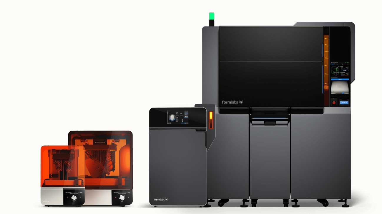 3D printing machines with a monitor and resin tanks displayed together.