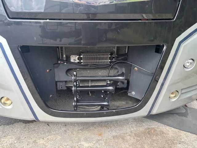 Front bumper grille opening three black air horn trumpets radiator cooler lines David's 2022 Winnebago Adventurer 35F Conductor's Special 232 train horn kit gallery photo 4