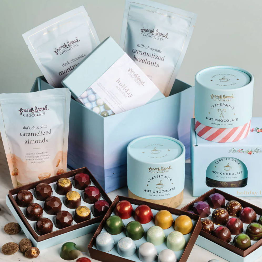 Assorted packaged chocolates and snacks arranged aesthetically on a light surface.