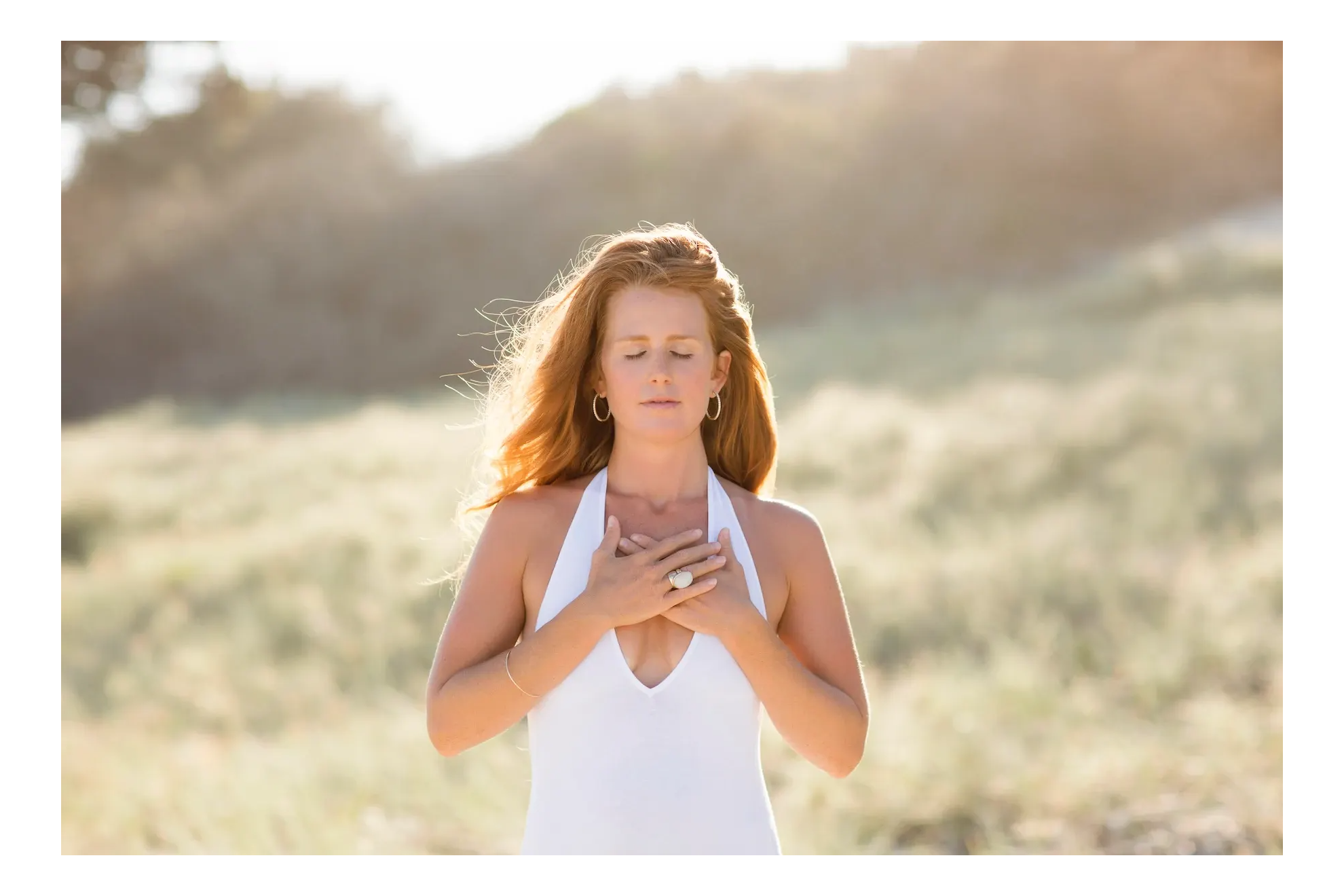 women with both hands over her heart