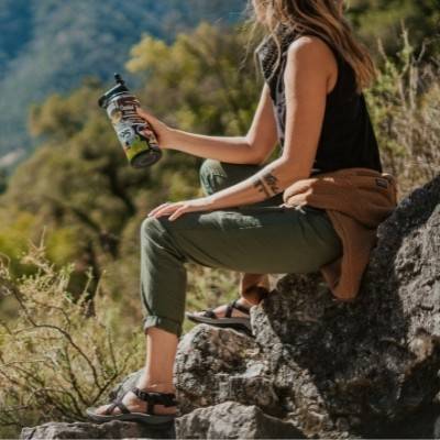 Woman on rocks wearing Cortona Sporty Sandals by Viakix 