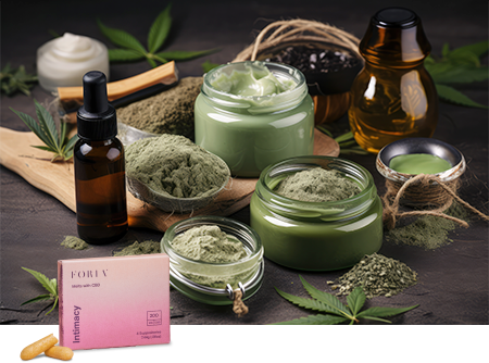 An array of hemp-based wellness products including oils, salves, and powders are displayed with raw hemp leaves against a dark tablecloth, suggesting a natural, holistic approach to health.
