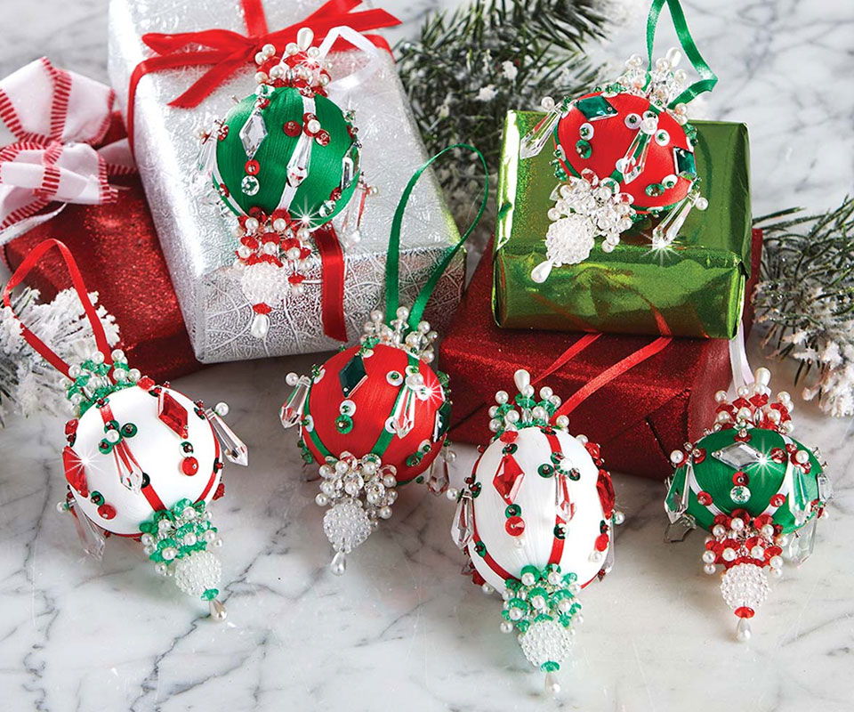 Colorful Christmas ornaments on wrapped gifts with festive decorations.