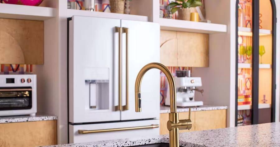 Cafe matte white appliances with Brushed Brass hardware and Kohler Vibrant Brushed Modern Brass Faucet 