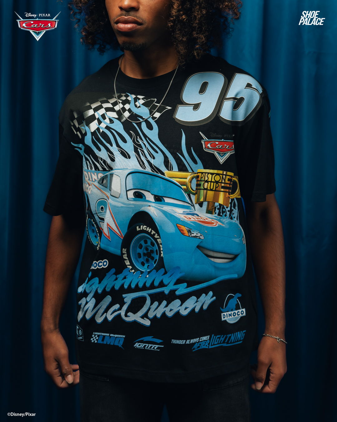 Person wearing a black t-shirt featuring Lightning McQueen from Cars with the number 95.