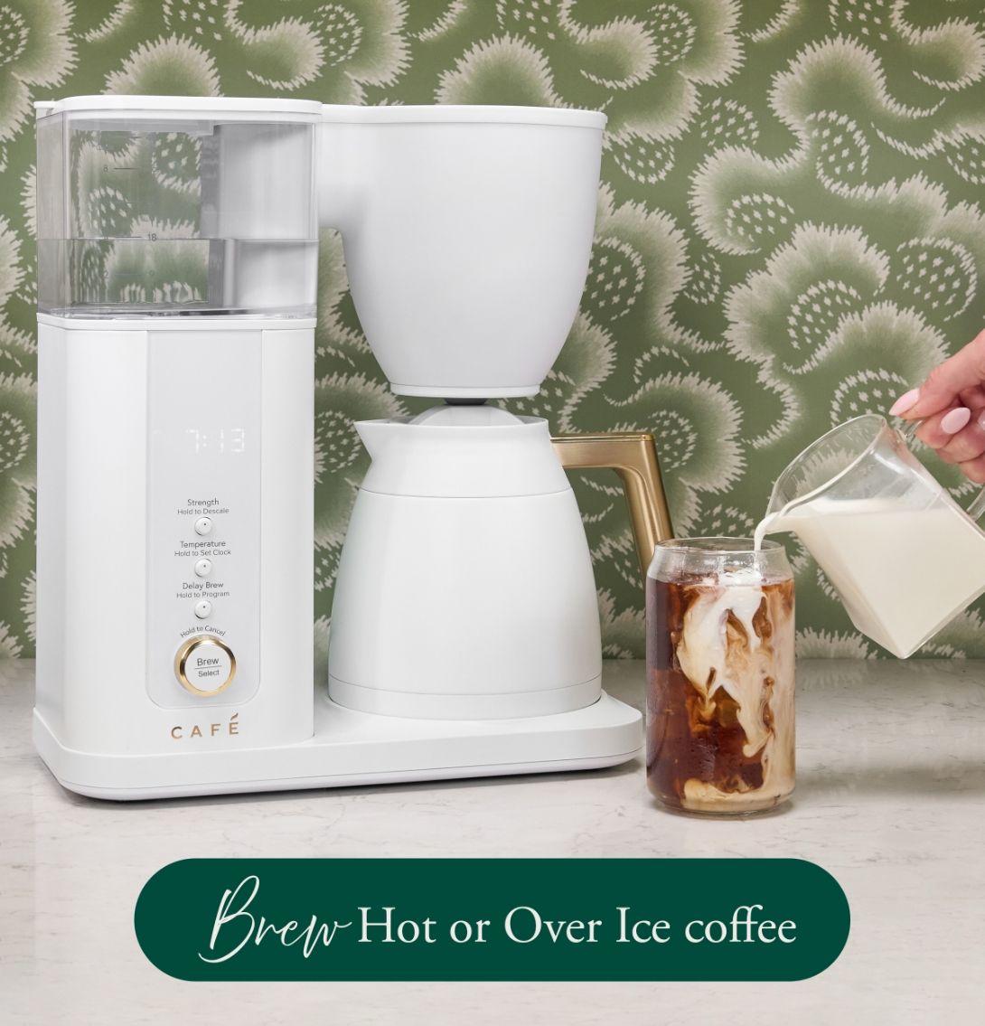 Coffee maker brewing hot or over ice coffee with milk being poured.