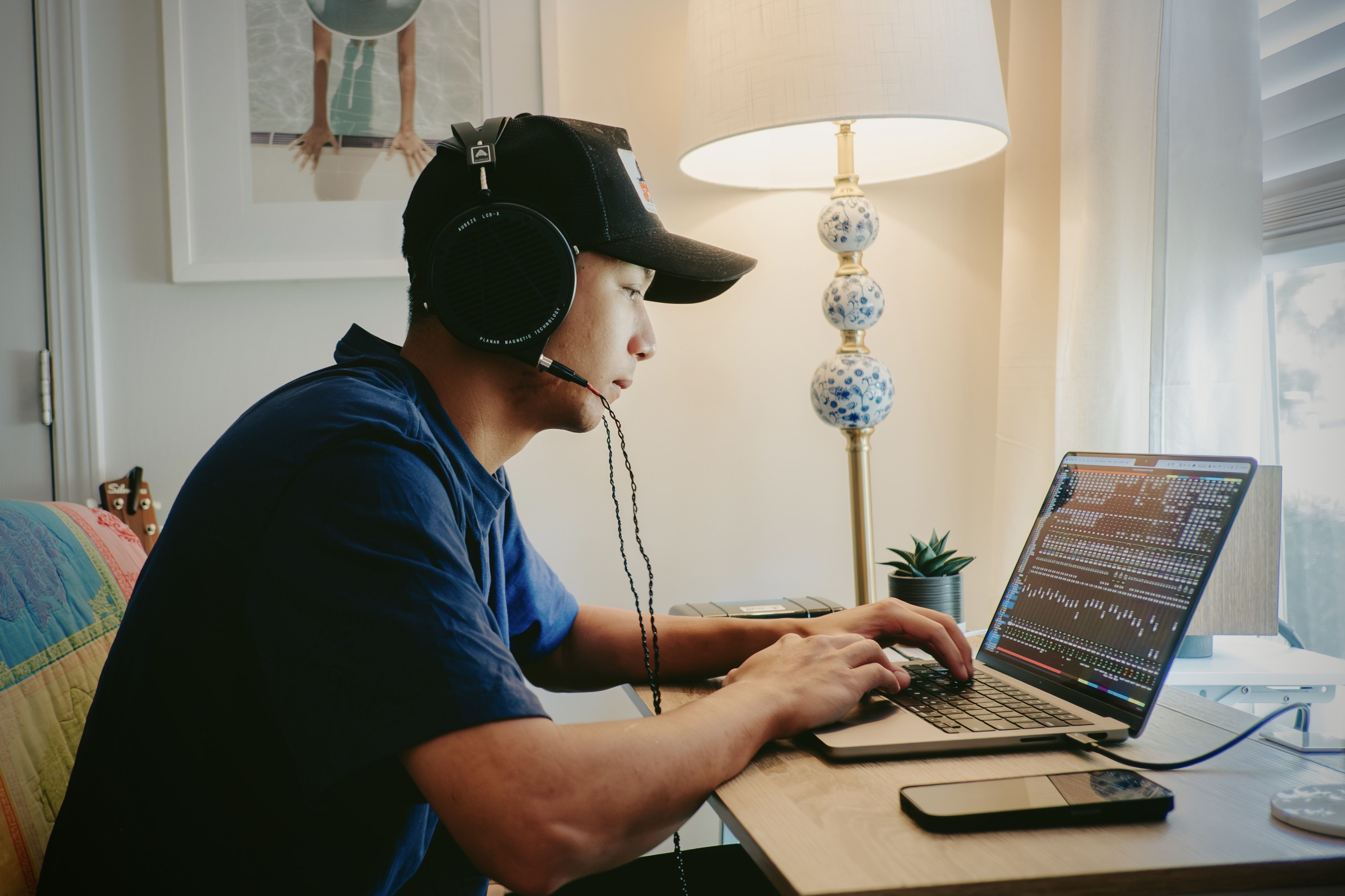 Matt Lee wearing Audeze LCD-X headphones mixing on a Mac