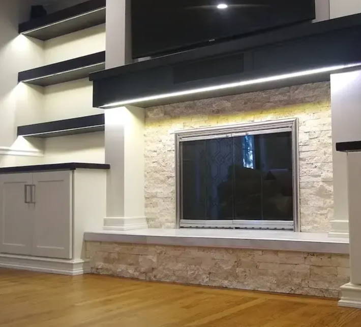 Living room with backlit built-in shelving using LED strip lights 
