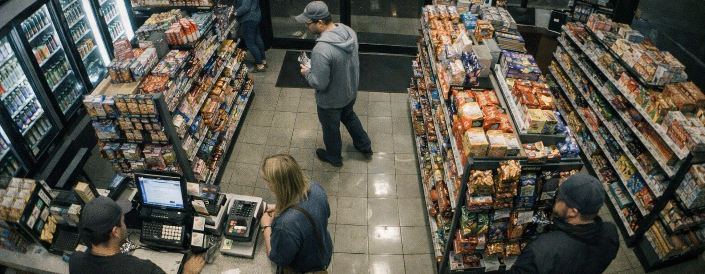 Overhead view from an X Series 4K security camera with real-time 30fps video showing customers shopping in a convenience store and a cashier at checkout.