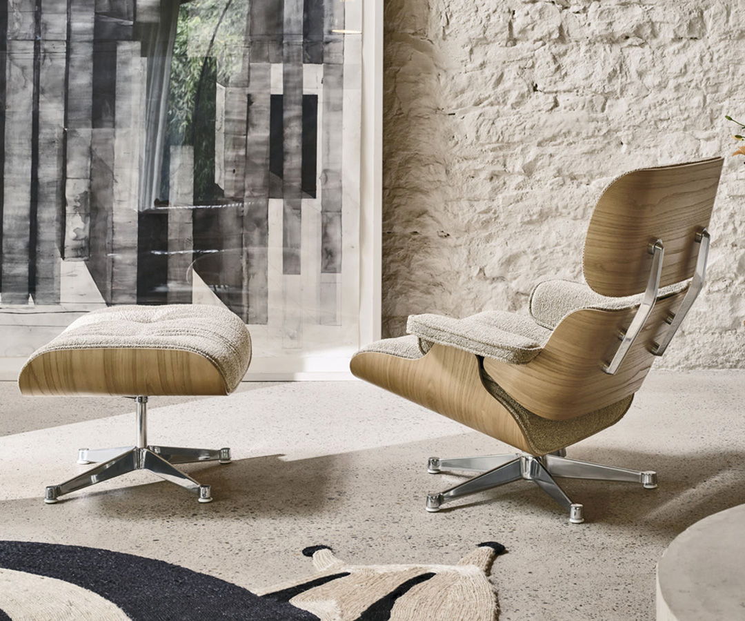 Modern Vitra lounge chair with matching ottoman in a stylish interior setting.