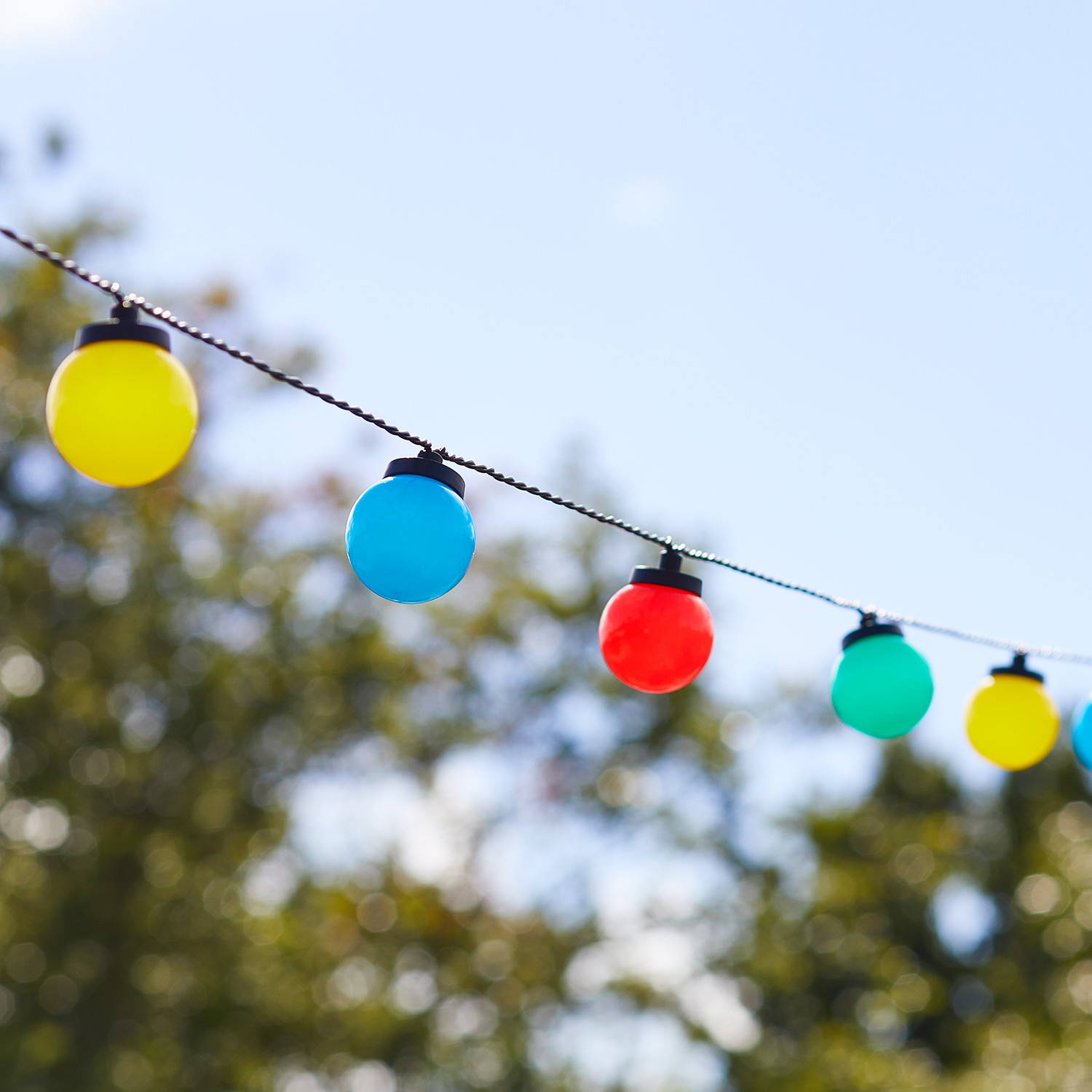 Multi coloured festival festoons hung in garden