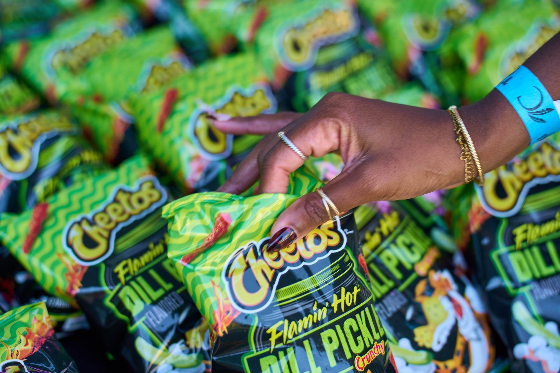 Guest reaching for a bag of Cheetos Flamin' Hot Dill Pickle Crunchy chips at The Big Dill Arlington Texas 2025.