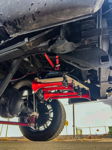HornBlasters red train horn kit with compressor secured to frame rails on lifted truck