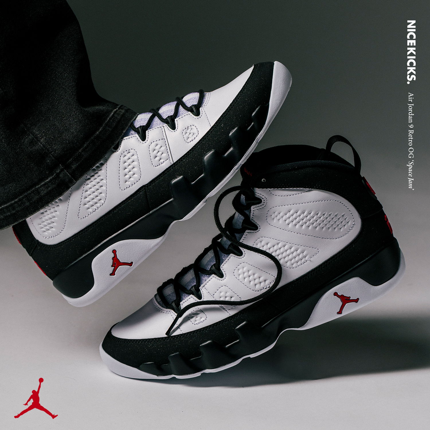 A pair of black and white Jordan sneakers on a gray background.