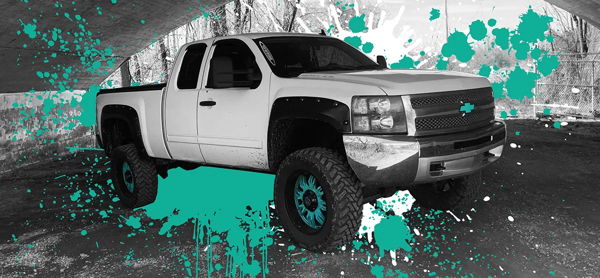Caitlyn's lifted white Chevrolet Silverado with teal wheel accents and paint splatter effect under overpass photo 1