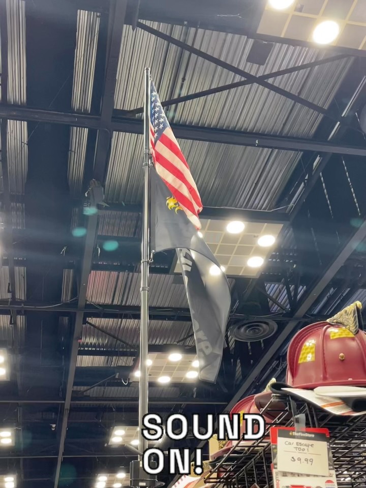American flag and black flag hanging indoors with 