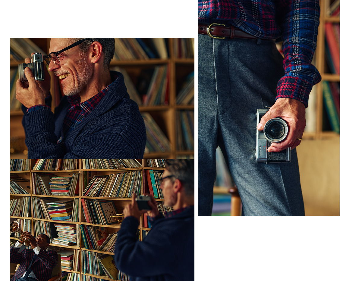 Man taking photos with a camera in a room filled with records.