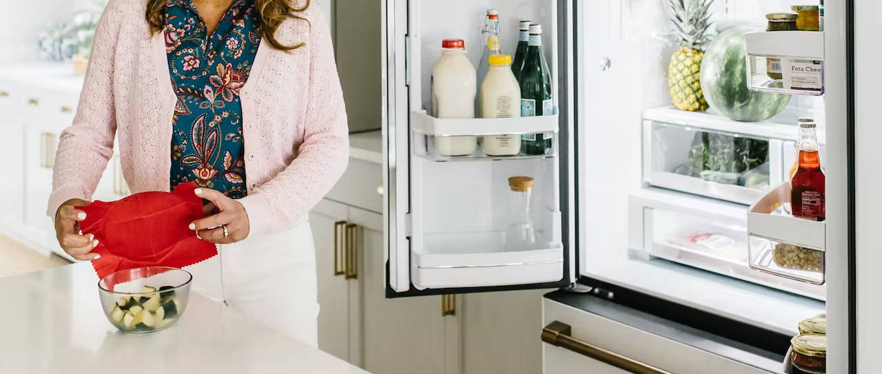 woman using wax cover for refrigerator storage