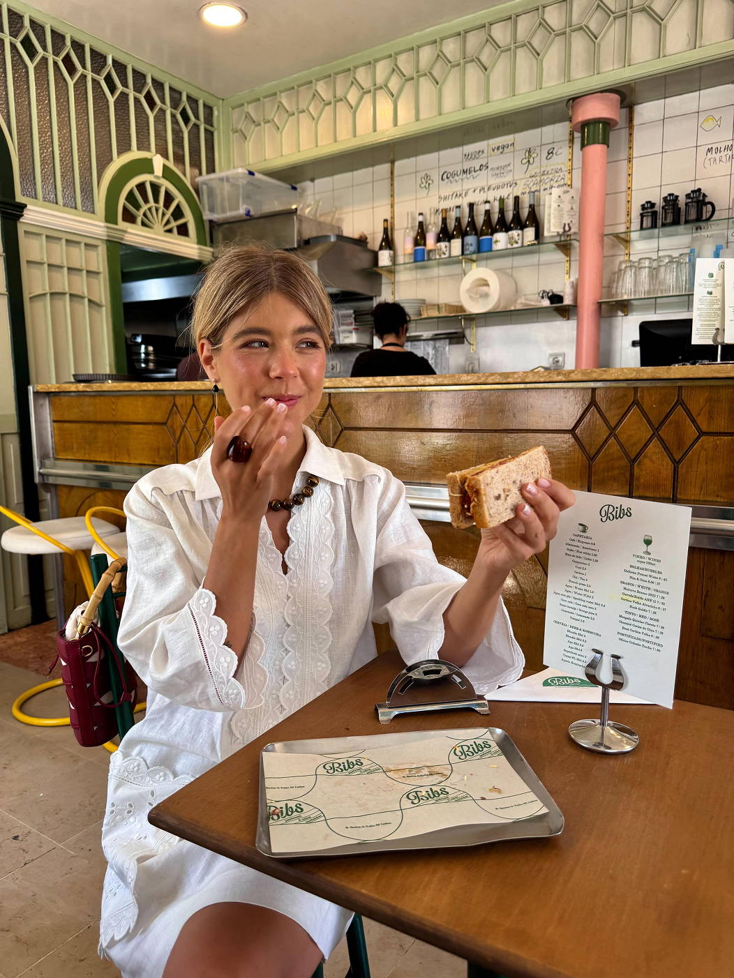 Model, Ines in a Lisbon cafe enjoying a sandwich.