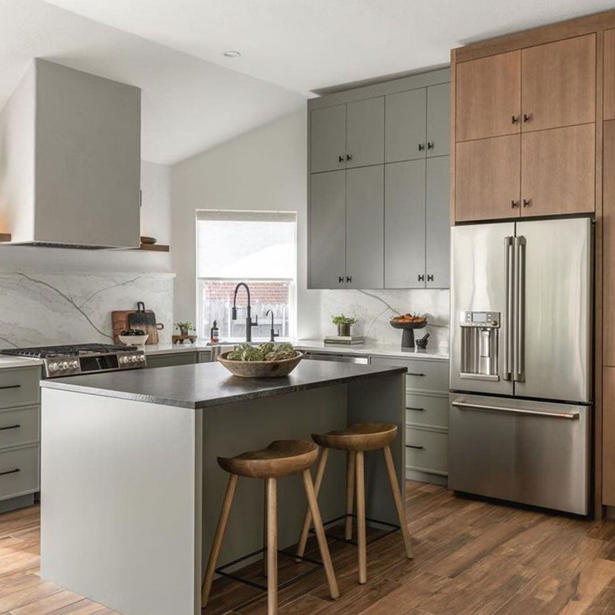 Cafe Stainless steel refrigerator in kitchen with gray and wood cabinets