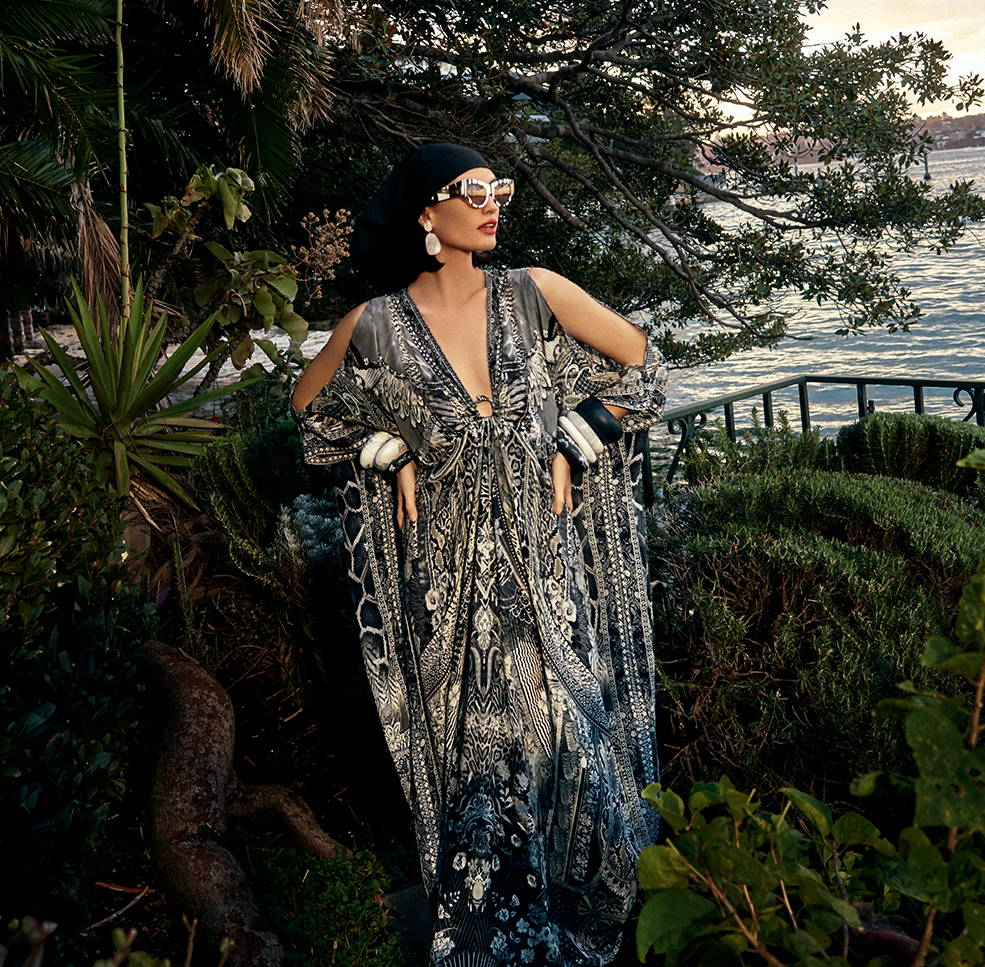 Model in garden wearing CAMILLA grey, white and black printed kaftan.