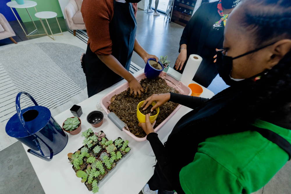 girls potting plants at for her event