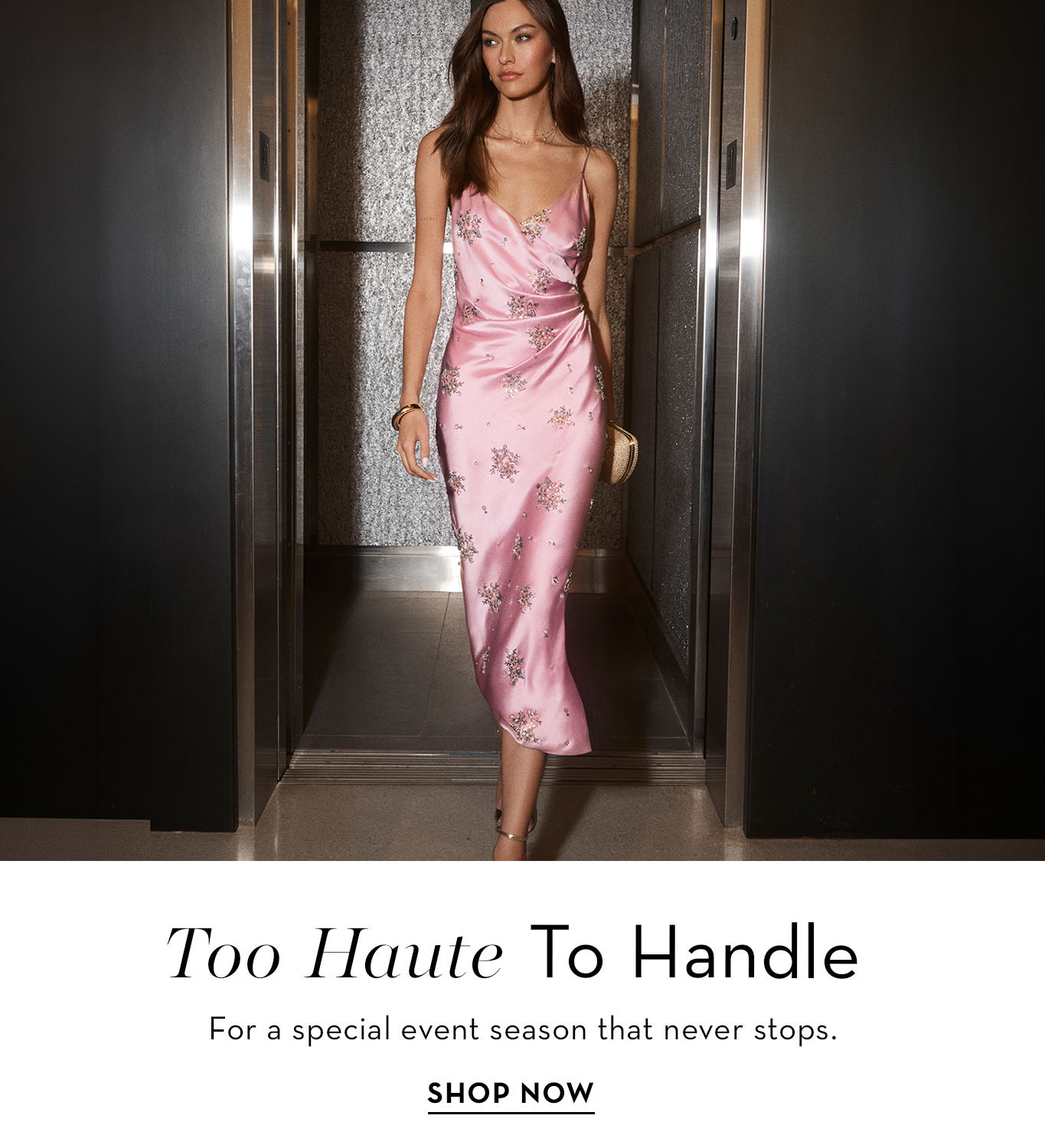 Model in a pink dress walking through an elegant setting.