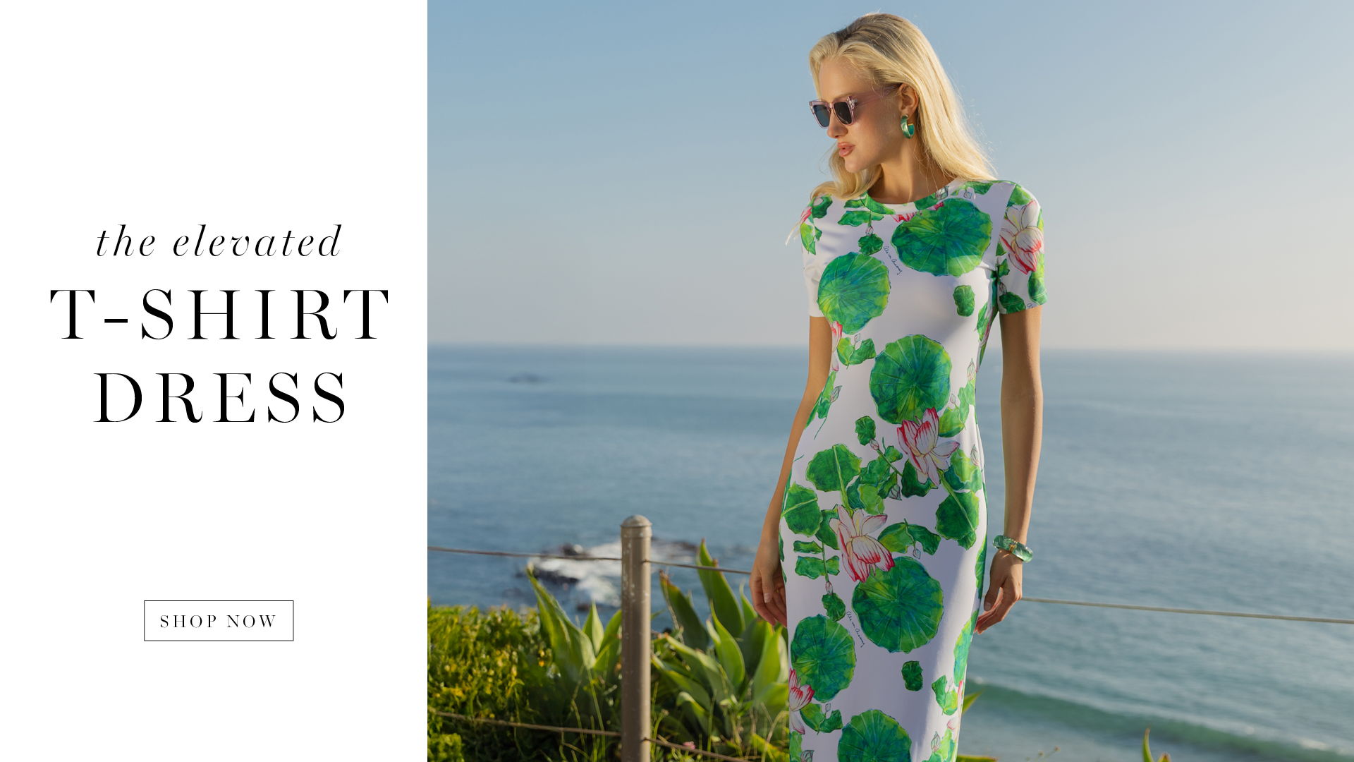 A woman in a floral dress stands by the ocean.