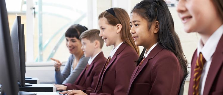 Students in formal blazers and ties at school computers