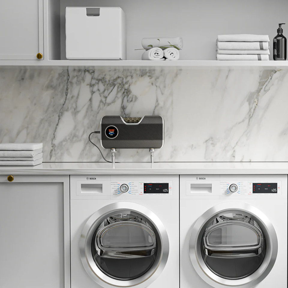 Laundry room with washing machines, shelves, and decorative items on marble countertop.