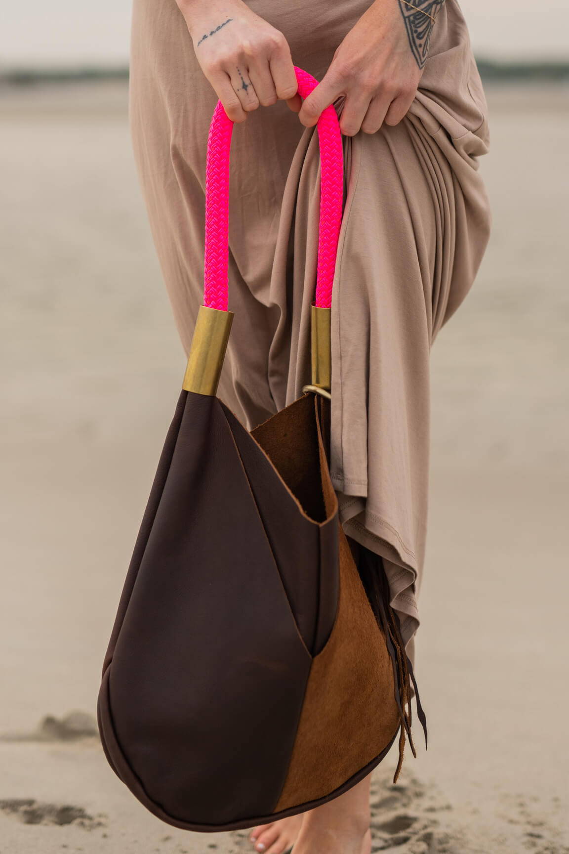 closeup on brown leather tote with pink dock line
