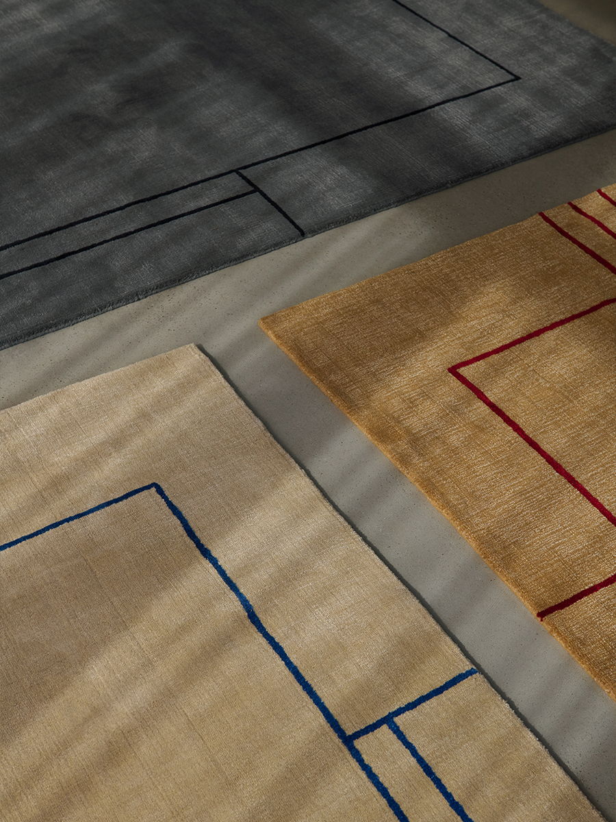 Abstract rugs with geometric patterns in gray and beige tones.