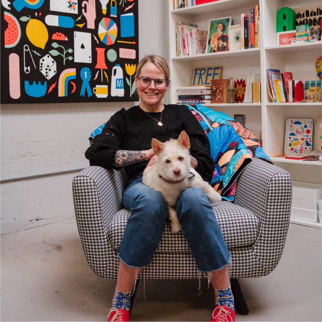 Lisa Congdon sitting in chair holding dog