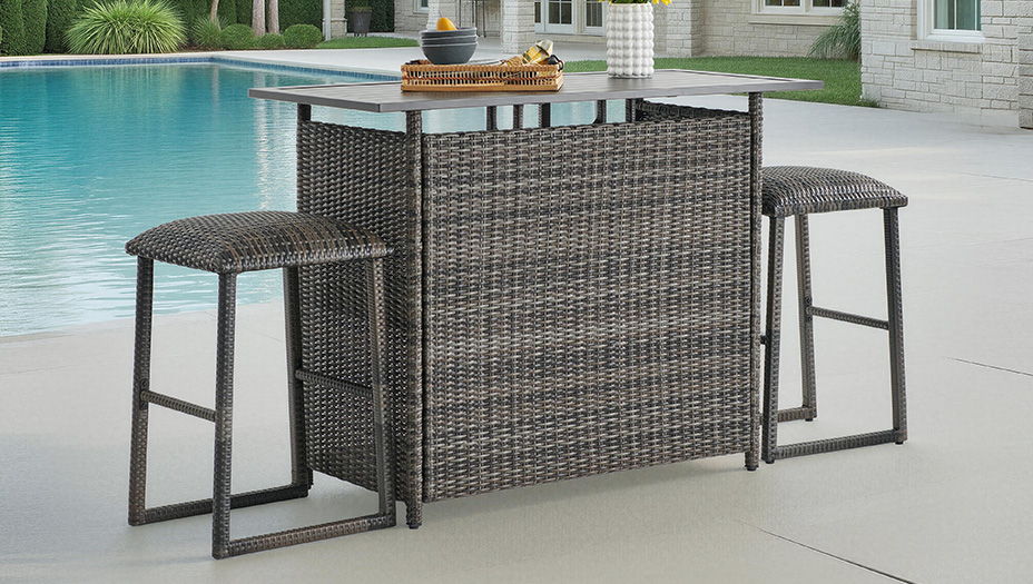 Outdoor bar with two stools beside a swimming pool.