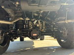 Rear undercarriage showing Mag-Hytec differential cover and four train horns with air suspension