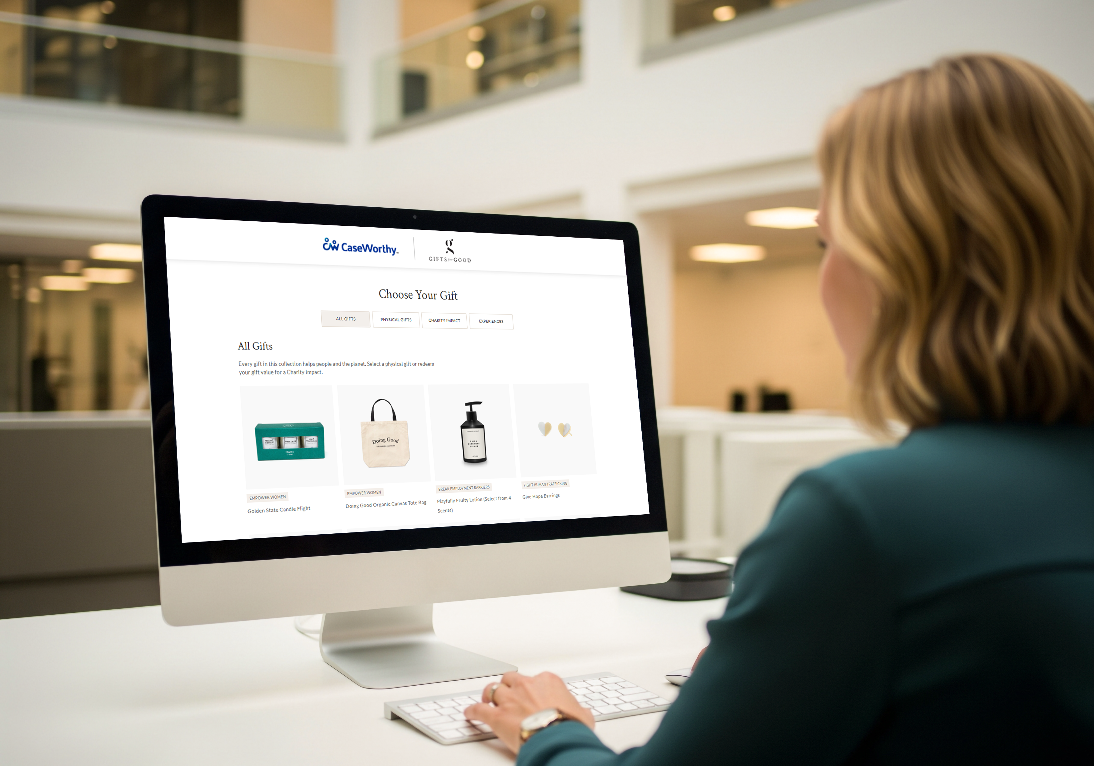 Person using a computer displaying products on a website in a modern office.